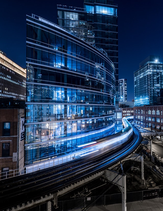 Glass Building at Night with Light Trails