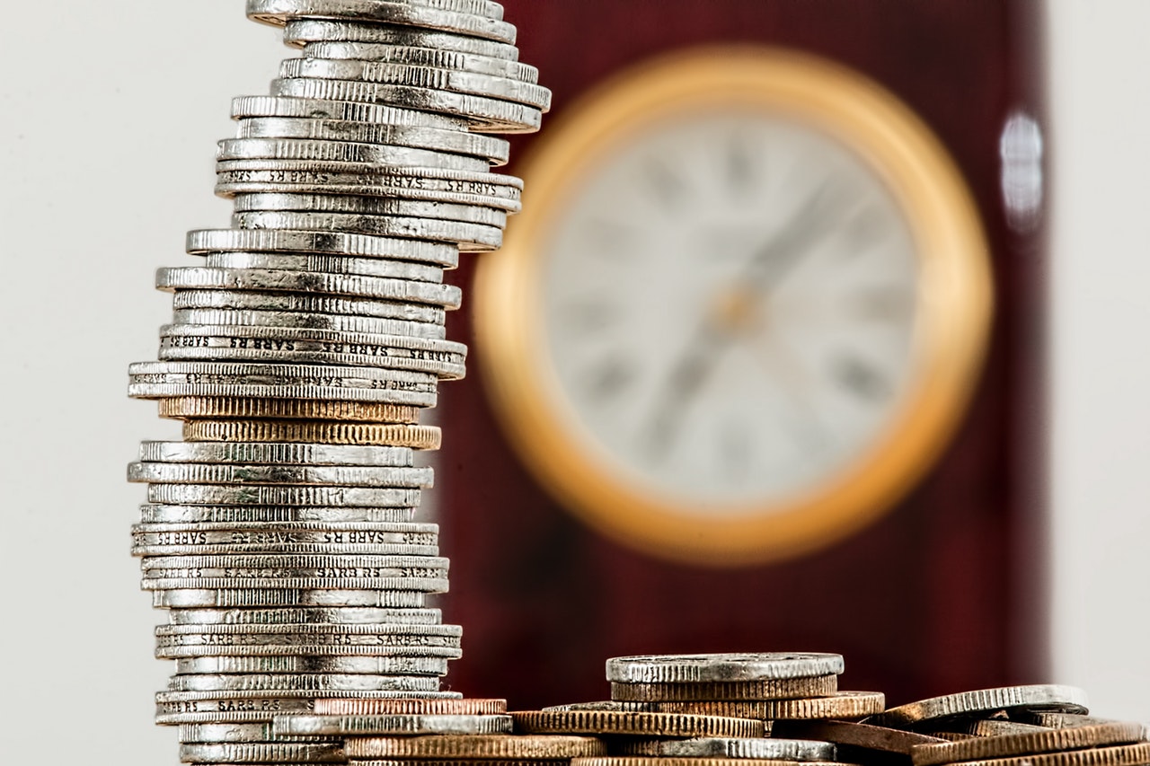 Old Coins with Clock in Background